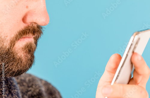 Man looking down at a mobil...