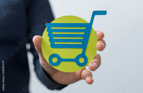 Hand holding a shopping car...