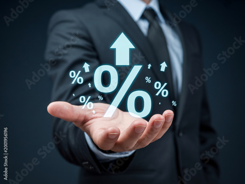 A businessman in a suit holds his hand out with a percentage sign and arrows indicating growth and increase