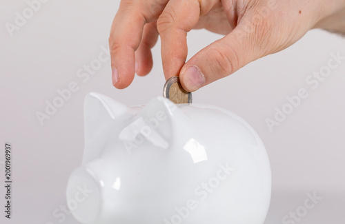 Hand inserting coin into wh...