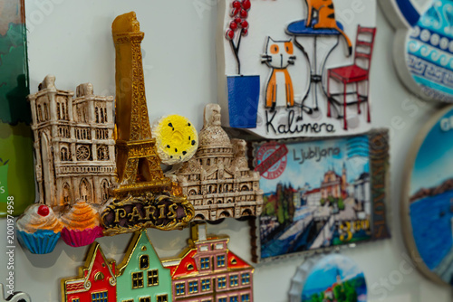 Travel souvenir magnets collection with Paris Eiffel Tower and Ljubljana city illustration, colourful tourism fridge decoration close-up
