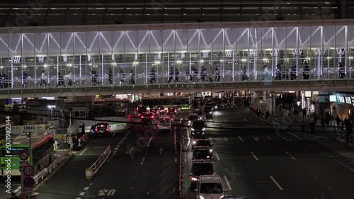 Night in Tokyo : As People Walk Along the Skyway Spanning the Urban Road of a Shopping District, Street Headlights, Intersection, and City Lights Create a Live   |  Shibuya Station, Tokyo, Japan