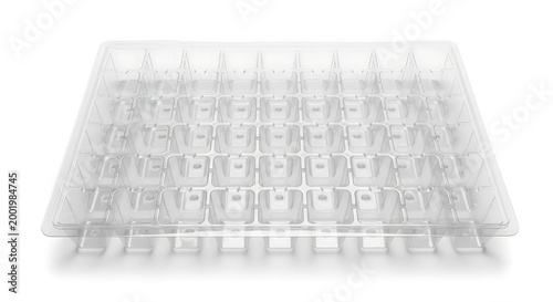 Empty transparent plastic blister packaging tray with multiple square compartments isolated on white background