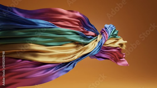 A vibrant, swirling abstract form created from flowing, colorful silk ribbons.