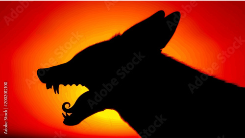 Silhouette of a howling coyote against a fiery sunset, symbolizing wildness and nature.