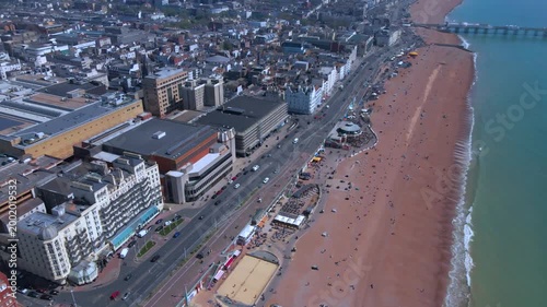 Aerial track over Brighton pebble beach and Victorian architecture