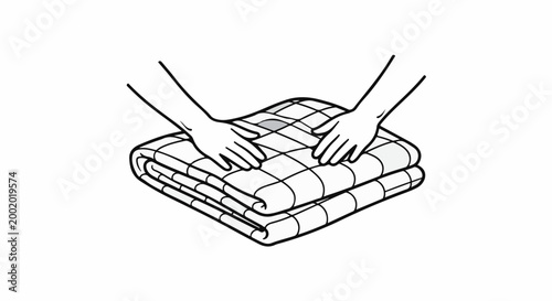 Hands folding a patterned blanket