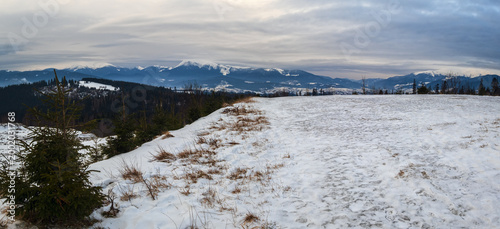 Winter evening overcast twilight mountains (Ukraine, Carpathians -  mountain peaks scenery view from Yablunytsia Pass).