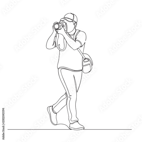 Continuous line drawing of male photographer in a cap with professional camera for taking photos.