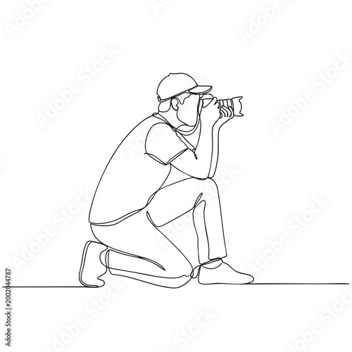 Continuous line drawing of professional photographer kneeling on one knee and taking picture with digital camera device.