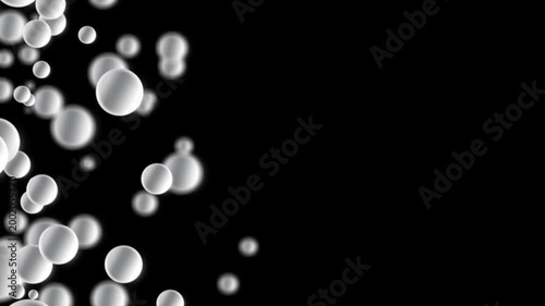 An abstract 3D silver spheres, bubbles slowly floating in the air in a dark space. A black background with floating spherical shapes and space for text, copy space