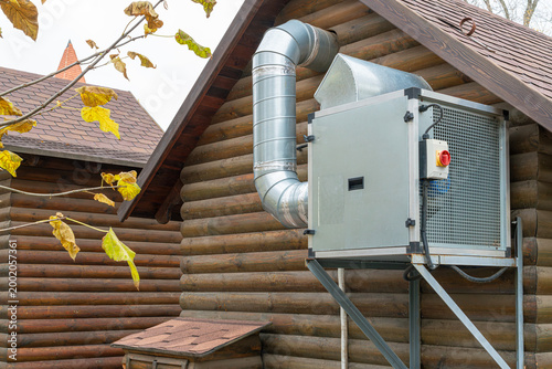 AC unit mounted on wooden house wall