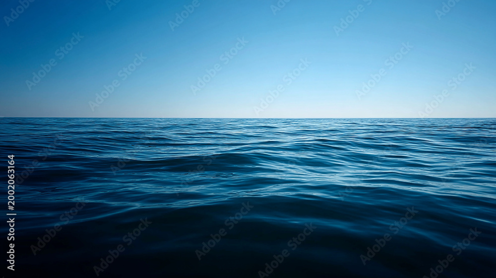 Fototapeta premium Vast deep blue ocean surface with ripples and clear sky on a bright sunny day tranquil seascape