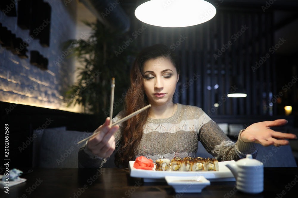 Fototapeta premium Beautiful girl in a cafe