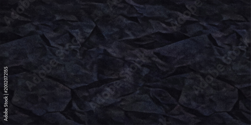 A dark grunge design featuring a wrinkled and crumpled black paper texture provides a blank, old material surface backdrop with a unique pattern for a textured wallpaper