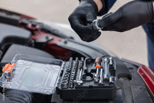 Canvas Print Hands selecting socket tool from kit for vehicle repair and maintenance work