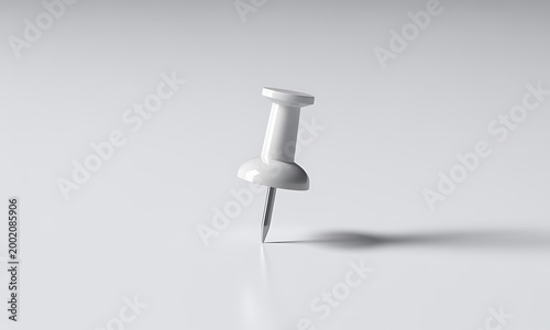 Single white push pin standing upright on a flat surface