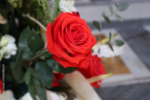 Foto Primo piano di una rosa rossa fresca in una composizione floreale elegante all'i