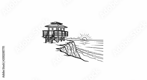 Lifeguard tower on cliff overlooking ocean at sunset
