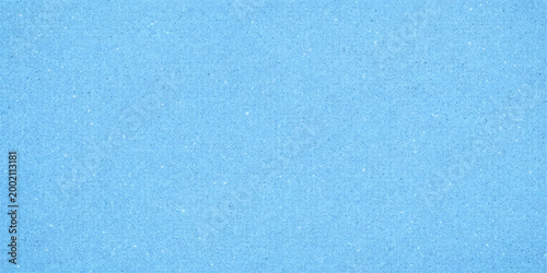 Bright blue paper texture background with a rough grunge pattern and aged vintage surface material for a blank retro wallpaper design