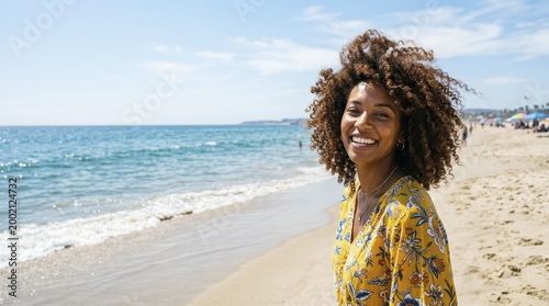 Happy Black woman smiling at the beach during summer vacation