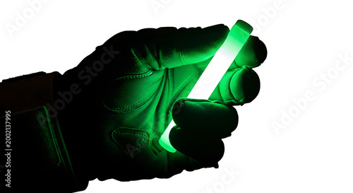 Vibrant Green Illuminating Stick Held by Gloved Hand, Isolated for Striking Visual Impact
