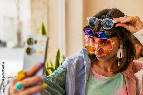 Canvas Print A girl is wearing a lot of sunglasses and is having fun