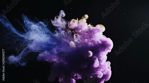 A mesmerizing abstract image showcases vibrant blue and purple ink swirling and blooming in water against a stark black background, creating a captivating visual display.