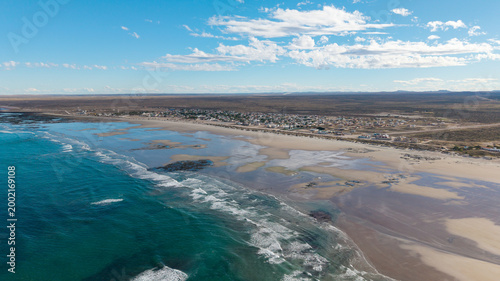 Εκτύπωση καμβά Turquoise waters and low tide at Playas Doradas, Rio Negro province
