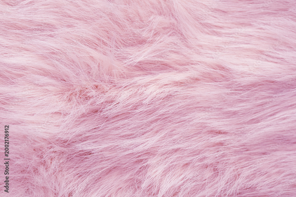 Fototapeta premium Detailed close up of soft delicate luxurious fluffy light pink faux fur fabric texture surface