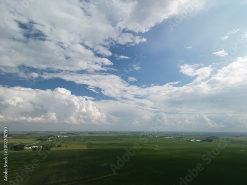 Almost like it was painted in this picture perfect quintessential Iowa farm landscapes shot with green growing crops in the fields as far as the eye can see. 