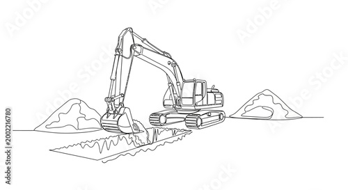 An excavator digs into a pile of dirt at a construction site with mountains in the background.