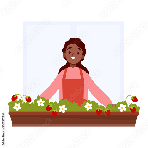 Happy Woman Tending Strawberry Plants on balcony