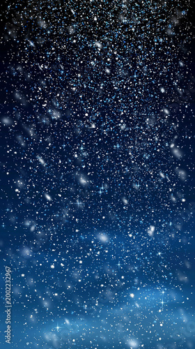 An abstract winter background with shimmering snowflakes, sparkling stars, and a blue glow against a dark backdrop. An atmospheric vertical composition for holidays, decor, and seasonal design.