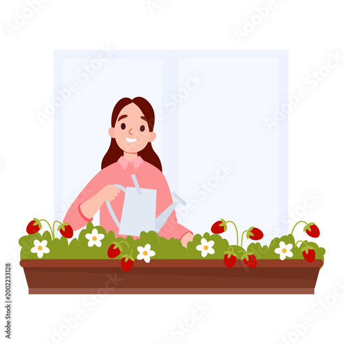 Woman Watering Strawberry Plants on balcony
