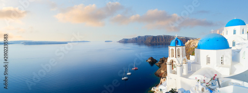 Obraz na płótnie white church belfry, blue domes and volcano caldera with sea landscape, beautifu