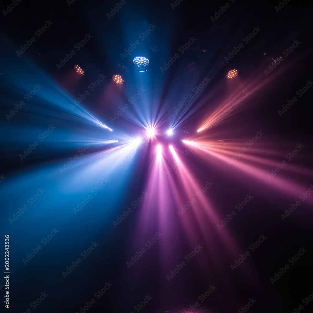 Fototapeta premium Colorful stage lights beams in dark background abstract nightclub lighting effect
