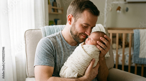 Father lovingly holding newborn baby in cozy living room setting  