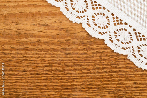 Konstfotografi White lace sits on a wooden surface showing texture and details of the materials
