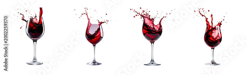 A crystal clear wine glass, filled with deep red wine, captured mid-pour with a dramatic splash