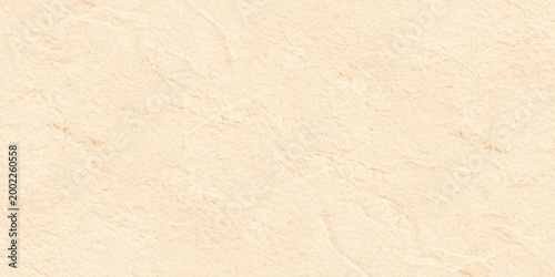Pale peach textured stone wall background with subtle grain and natural plaster finish for minimalist interior design