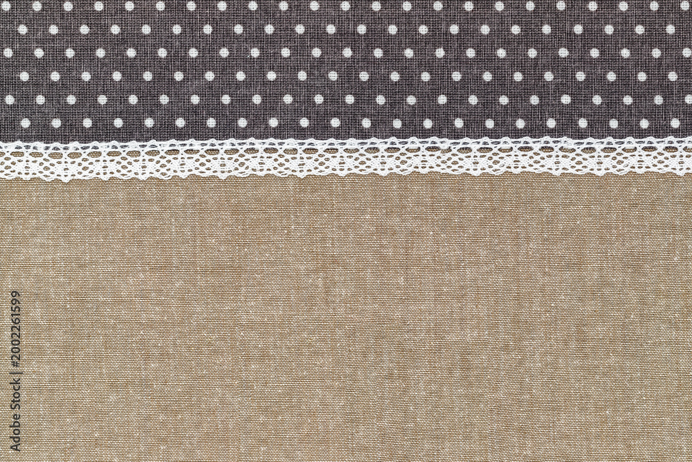 Fototapeta premium Fabric with polka dots and lace showing a sewing project in progress at home during daylight hours