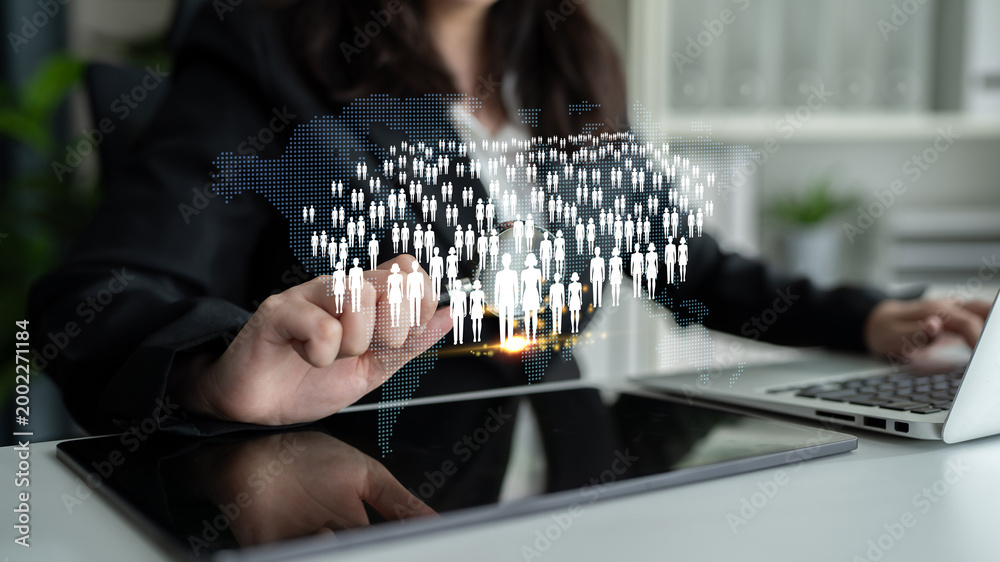 Obraz premium Business professional interacts with digital population map, symbolizing networking and global connections in a modern workspace setting Quark.