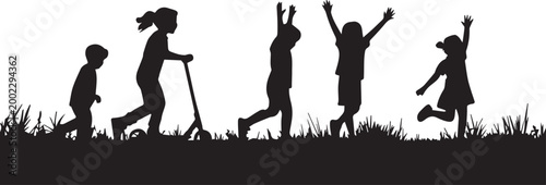 A group of happy children playing and jumping in a grassy field on a sunny day in silhouette