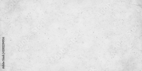 White concrete wall texture background with subtle grain and light grey distressed stone effect. white cement or plaster wall texture. light grey weathering and a fine granular surface