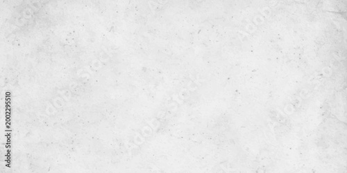 White concrete wall texture background with subtle grain and light grey distressed stone effect. white cement or plaster wall texture. light grey weathering and a fine granular surface
