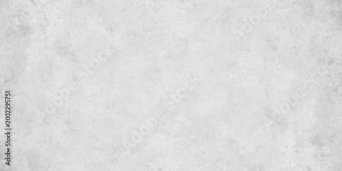 White concrete wall texture background with subtle grain and light grey distressed stone effect. white cement or plaster wall texture. light grey weathering and a fine granular surface