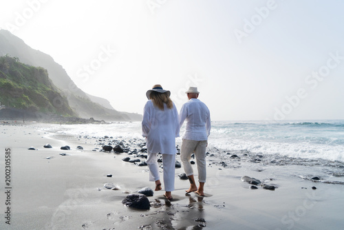 lifestyle of caucasian senior couple drinking champagne on beach, happy in love romantic and relax time, tourism of elderly family pleople, leisure and activity travel after retirement