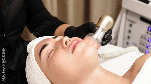 Fotografia Young client receives RF lifting to improve skin elasticity and tone