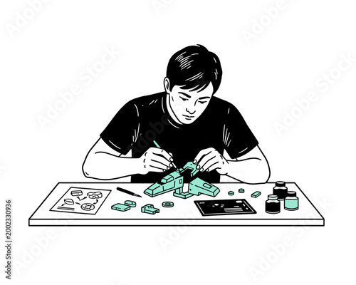 Young man focused on building and painting a plastic model kit illustration
